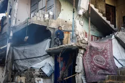 Filistinli kız çocuğu, Gazze Şeridi'nin kuzeyindeki Cibaliye'de yıkılmış bir binadan dışarı bakıyor (Reuters)