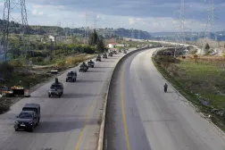 Military vehicles drive along a road as the last Kurdish-led Syrian Democratic Forces (SDF) fighters left the Syrian city of Aleppo on Sunday, state-run Ekhbariya TV said, following a ceasefire deal that allowed evacuations after days of deadly clashes, in Latakia, Syria, January 14, 2026. (Reuters)