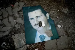A damaged portrait of Syria's ousted President Bashar al-Assad lies on the ground in the western Syrian port city of Latakia on Dec. 15, 2024. (AFP via Getty Images) 