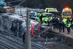 Members of the Spanish Civil Guard, along with other emergency personnel, work next to one of the trains involved in the accident, at the site of a deadly derailment of two high-speed trains near Adamuz, in Cordoba, Spain, January 19, 2026. (Reuters)