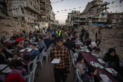 Palestinians share the iftar meal amid homes destroyed by Israeli bombardment in Gaza on Sunday (EPA). 