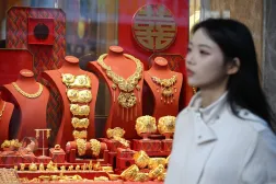 A woman passes by a gold shop in Hong Kong (AFP)