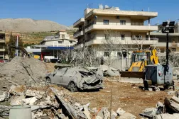 A bulldozer clears debris near heavily-damaged buildings in the village of Bednayel in Lebanon's eastern Bekaa Valley region on February 21, 2026, following Israeli strikes. (AFP)