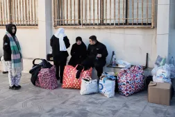 A displaced family who fled Israeli airstrikes in southern Lebanon sits at a school turned into a shelter, in Beirut, Lebanon, Monday, March 2, 2026. (AP Photo/Bilal Hussein)