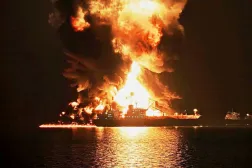 An oil tanker burns after being hit by an Iranian strike in the ship-to-ship transfer zone at Khor al-Zubair port near Basra, Iraq, late Wednesday, March 11, 2026. (AP Photo)