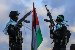 FILED - 20 February 2025, Palestinian Territories, Khan Younis: Hamas fighters stand guard at the site where Hamas handed over the bodies of four Israeli hostages to the Red Cross in Khan Yunis. Photo: Abed Rahim Khatib/dpa