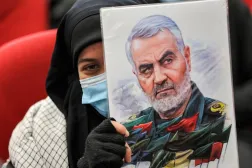 A woman in Lebanon's capital Beirut with a portrait of slain Iranian commander Qassem Soleimani during a January 3, 2022 service marking the second anniversary of his killing. (AFP)