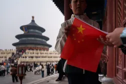  A child holds a Chinese national flag near the Hall of Prayer for Good Harvests in Beijing, China, Friday, April 3, 2026. (AP) 