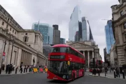 Buses pass in front of the Bank of England building in London (Reuters)