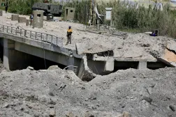 A man stands on a damaged part of the Qasmiyeh Bridge that was targeted by an Israeli airstrike near Tyre, southern Lebanon, 16 April 2026. EPA/STRINGER