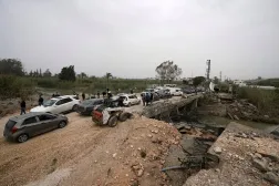 Displaced people cross a destroyed bridge which was hit few days ago in an Israeli airstrike, as they return to their villages on the second day of a ceasefire between Hezbollah and Israel in Qasmiyeh, near Tyre city, southern Lebanon, Saturday, April 18, 2026. (AP) 