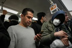 A man uses his smartphone while riding the subway in Tehran, Iran, Tuesday, Dec. 24, 2024. (AP)