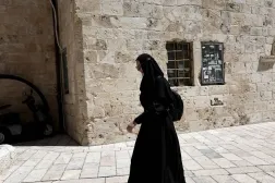 A nun passes by the last supper room area outside of Jerusalem old city, 01 May 2026. (EPA)