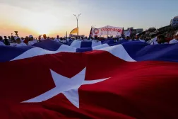 People march while holding a giant Cuban national flag during a May Day rally in Havana, Cuba, May 1, 2026. (Reuters)