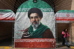 A woman walks next to a banner with a picture of Iran's new Supreme Leader Mojtaba Khamenei in Tehran, Iran, May 8, 2026. Majid Asgaripour/WANA (West Asia News Agency) via Reuters