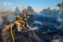 In this photo provided by the Ukrainian Emergency Service, emergency services personnel work to extinguish a fire following a Russian drone attack in Kyiv region, Ukraine, Tuesday, May 12, 2026. (Ukrainian Emergency Service via AP) 