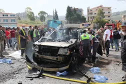 Lebanese rescuers and army soldiers inspect the wreckage of a vehicle that was hit in an Israeli strike in Jiyyeh town, south of Beirut, Lebanon, 13 May 2026. (EPA) 