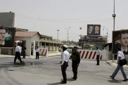 Police stand at the gate of Damascus Central Prison in the Adra area near the Syrian capital of Damascus in this May 28, 2010 file photo. REUTERS/Khaled al-Hariri/Files/File 