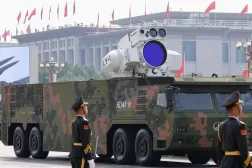 Çin Halk Kurtuluş Ordusu mensupları, İkinci Dünya Savaşı'nın sona ermesinin 80. yıl dönümü dolayısıyla 3 Eylül 2025'te düzenlenen askeri geçit töreninde hava savunmasına yönelik bir lazer silahı sergilenirken hazır kıta duruyor (Arşiv - Reuters)