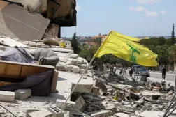  A Hezbollah flag flutters amid rubble of destroyed buildings, in Deir Qanoun al-Nahr, Tyre district, southern Lebanon, June 15, 2026. (Reuters)