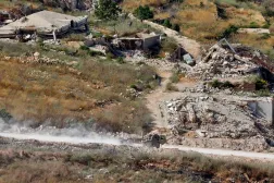 This picture taken from a position in northern Israel, near the border with Lebanon shows an Israeli military vehicle driving along a road in southern Lebanon on June 22, 2026. (AFP)