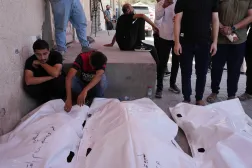 Palestinians mourn victims killed in an Israeli strike on a residential building in central Gaza on Wednesday. (AP)