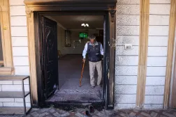 A Palestinian man checks the torched entrance at the damaged Al-Taqwa mosque, whose walls were also daubed with Hebrew graffiti in an attack allegedly carried out by Israeli settlers in the Palestinian village of Al-Tuwani, south of Yatta, near Hebron in the occupied West Bank on July 19, 2026. (AFP) 