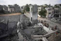 Palestinians inspect a destroyed building at the site of an Israeli airstrike, at al-Bureij refugee camp, central Gaza Strip, Friday, July 24, 2026. (AP)