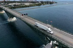 This aerial view shows a Capital Southern Transportation, Inc. truck passing over the Peace Bridge between Canada and the US in Fort Erie, Ontario, on August 18, 2026. (AFP)
