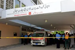 Police officers move past an ambulance outside an intensive care unit after a fire broke out at the Pakistan Institute of Medical Sciences (PIMS) hospital in Islamabad, Pakistan, August 26, 2026. (Reuters)