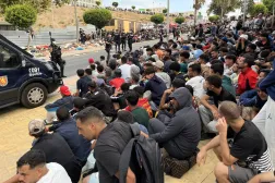 Migrants wait outside the Loma Colmenar temporary migrant shelter in Ceuta, Spain, 31 August 2026. (EPA)