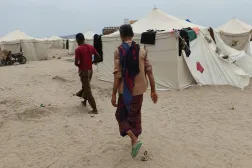  People walk past tents in al-Firdaws camp in Aden province, amid clashes between Iran-aligned Houthi fighters and Yemeni government forces, in Aden, Yemen, September 17, 2026. (Reuters)