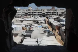  Displaced Palestinians walk through a tent camp inside a school-turned-shelter in Khan Younis, in the southern Gaza Strip, September 10, 2026. (Reuters)
