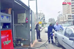 FILE - This file photo released on April 7, 2019, by the Syrian official news agency SANA, shows a worker filling a pickup at a gas station, in Homs, Syria. (SANA via AP, File)