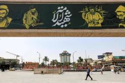 People walk near a giant billboard depicting portrayals of Iran's slain supreme leader Ali Khamenei through various periods in his life, in Baghdad's central Tahrir Square on September 22, 2026. (Photo by AHMAD AL-RUBAYE / AFP)