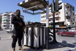 A member of the Syrian security forces stands guard along a street in Latakia, Syria March 10, 2025. (Reuters) 