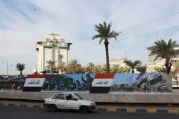 A car moves past a sign depicting Iraqi flags and images of Iraqi security forces on Sovereignty Day, marking the withdrawal of US-led coalition forces from Iraq, thereby ending more than two decades of military presence there, in Baghdad, Iraq, September 30, 2026. REUTERS/Ahmed Saad