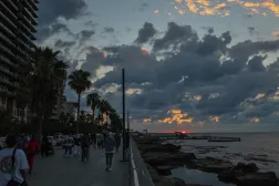 People walk along the Corniche Al-Manara seafront promenade on the coast of the Mediterranean Sea as the sun sets in Beirut, Lebanon, 30 September 2026. (EPA)