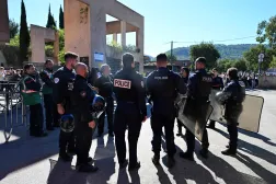 Policemen stand in front of Joseph-Lakanal high school after a headmaster was injured by a hunting rifle shot and a teenager was arrested in Aubagne, southern France, on October 12, 2026. (Photo by Miguel MEDINA / AFP)
