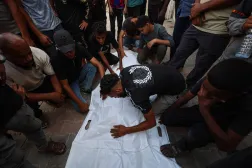 Mourners grieve over the bodies of three Palestinians during their funeral at Al Shifa Hospital in Gaza City on October 25, 2026, after they were killed in an Israeli strike on the Islamic University building. (Photo by Omar AL-QATTAA / AFP)