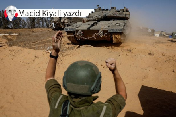 İsrail ile Gazze arasındaki sınır yakınlarında bir tankı yönlendiren bir İsrail askeri (Reuters)
