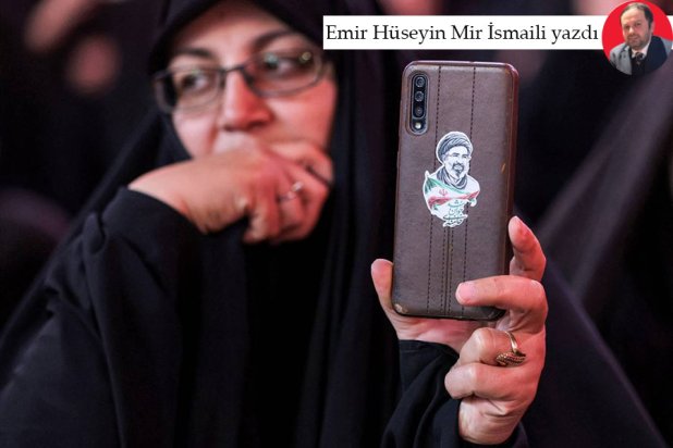 Telefonunun arkasına Mücteba Hamaney resmi yapıştıran İranlı bir kadın (AFP)