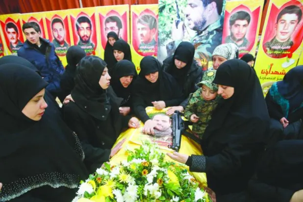 أقارب القيادي في حزب الله محمد عيسى الذي قتل بالغارة الإسرائيلية في مدينة القنيطرة السورية أثناء تشييع جثمانه في بلدة عربصاليم جنوب لبنان (ويترز)