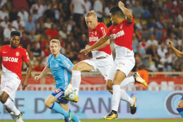 كاميل غليك (في الوسط) يسجل لموناكو في مرمى مرسيليا (رويترز)