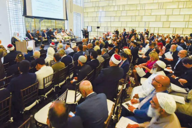 العيسى خلال كلمته ويبدو المشاركون في الفعاليات والحضور (الشرق الأوسط)