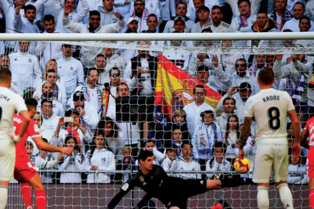 ستواني لاعب جيرونا (يسار) يسجل هدف فريقه الأول في مرمى الريال من ركلة الجزاء (أ.ف.ب)