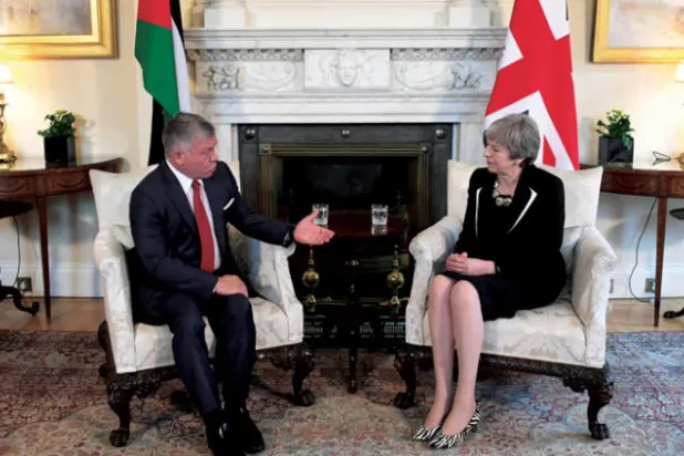 العاهل الأردني الملك عبد الله الثاني مع رئيسة الوزراء البريطانية تيريزا ماي في لندن أمس (رويترز)