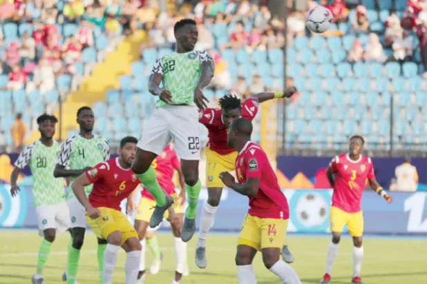 أوميرو مدافع نيجيريا يقفز أعلى من الجميع ليسجل برأسه في مرمى غينيا (رويترز)