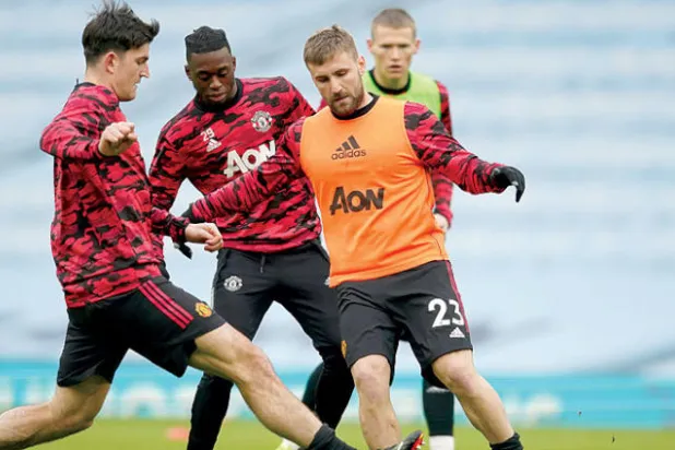 لاعبو مانشستر يونايتد خلال التحضير لمواجهة ميلان اليوم (أ.ب)