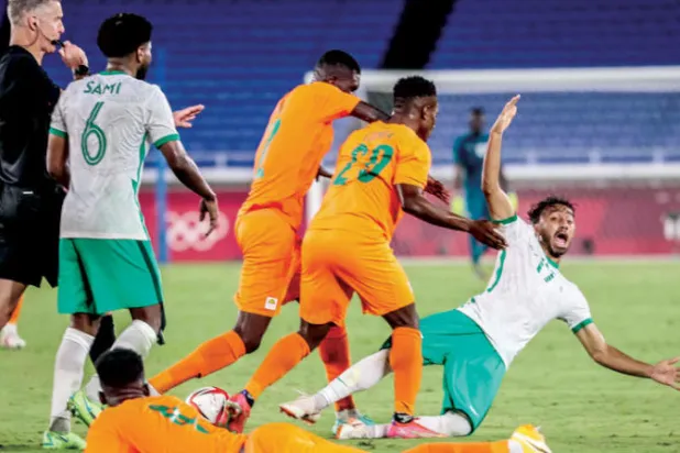 أيمن خليف لاعب الأخضر خلال تعرضه للاعتداء الذي طرد على أثره لاعب ساحل العاج أبو بكر دومبيا (أ.ف.ب)